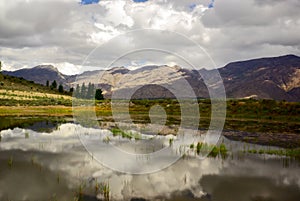 Clouds reflect in clear mountain lake in africa