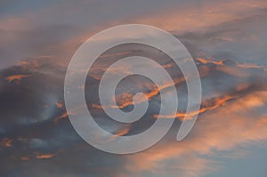 Clouds reflect light and colors at sunset.