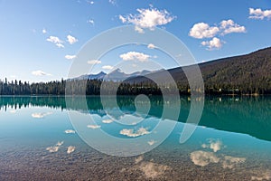 Clouds reflected in the beautiful waters of Emerald Lake in Canada`s Yoho National Park.