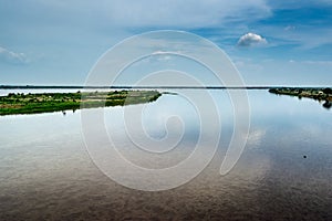 The clouds are reflected in the waters of the Magdalena River. Colombia. photo