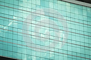 Clouds reflected in windows of modern office