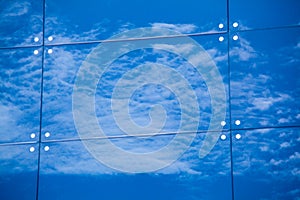 Clouds reflected in windows of modern office building