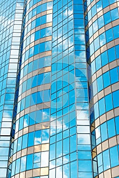 Clouds reflected in windows of modern office building