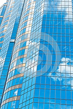 Clouds reflected in windows of modern office building