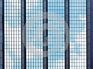 Clouds reflected in windows of modern office building