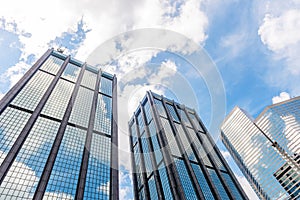 Clouds reflected in windows of modern office building