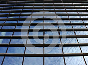 Clouds reflected in windows of modern office building