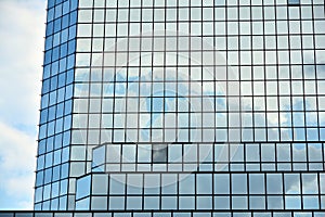 Clouds reflected in windows of modern office building