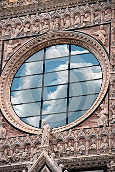 Clouds reflecting on church window in Italy