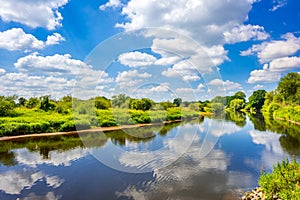 Clouds reflecting in Ems River, Emsland, Germany