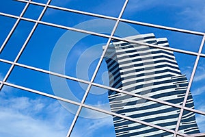 A clouds reflection in glass wall of skyscraper