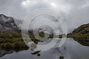 Clouds reflection in mountain lake near Punta Union pass. Huascaran National Park, Cordillera Blanca - Santa Cruz Circuit