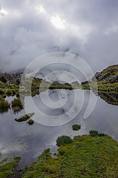 Clouds reflection in mountain lake near Punta Union pass. Huascaran National Park, Cordillera Blanca - Santa Cruz Circuit