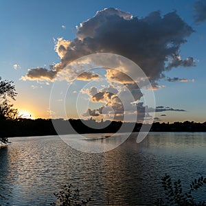 Clouds reflections and beautiful colors of a tranquil sunset at Lake Alice