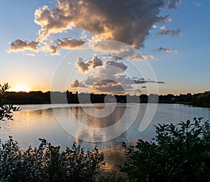 Clouds reflections and beautiful colors of a tranquil sunset at Lake Alice