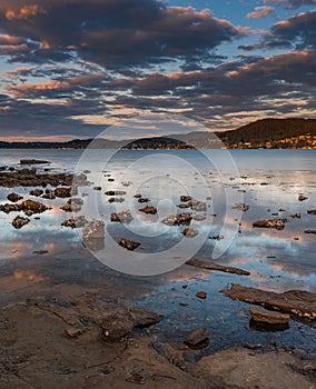 Clouds and reflections sunset over the water