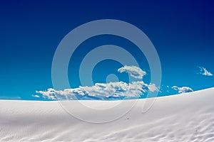 Clouds Rise Above Smooth Sand Dune