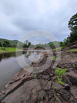 Clouds river bridge and green hills during monsoon