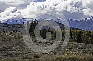 Clouds roll over snow capped mountains of The Grand Tetons.