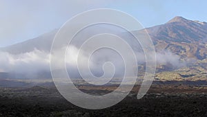 Clouds Rolling Across Plains Near Volcano