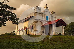 Clouds rolling in on an old chapel