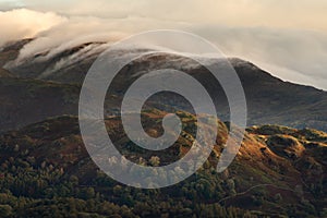 Clouds rolling over mountains on an Autumn morning in the Lake District, UK.