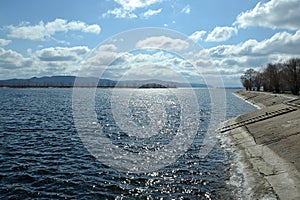 Clouds run across the sky over the river expanse