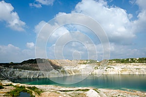 Clouds shadows on the chalk hills and on the bright turquoise water of the lake