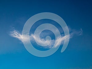 Clouds in the shape of beautiful angel wings. The sky changes from dark blue to light blue