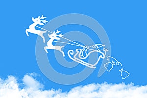 Clouds shaped Santa Claus driving in a sledge on blue sky