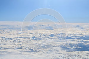 Clouds and sky as seen through window of an aircraft