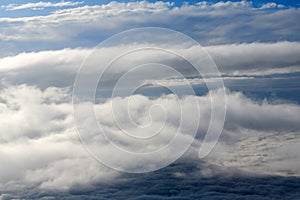 Clouds and sky as seen through window of an aircraft