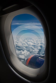 Clouds and sky as seen through window of an aircraft