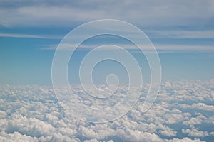 Clouds and sky as seen through window of an aircraft