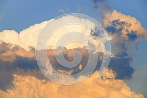 Clouds and sky. A large thundercloud against blue sky at sunset