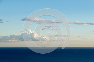 Clouds in the sky over the sea and horizon photo