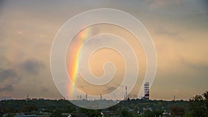 Clouds in the Sky and Rainbow are Moving over the City, buildings and Plant Pipes. Time Lapse