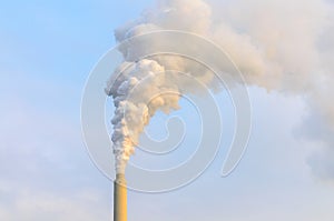 Clouds of smoke belching from industrial chimney