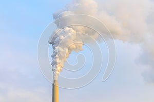 Clouds of smoke belching from industrial chimney photo
