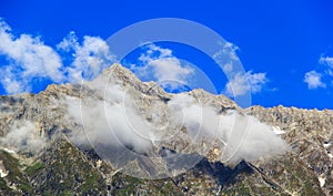 Clouds in the snowy mountains near Manali in Himalayas. photo