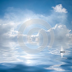 Clouds and sun reflection in water