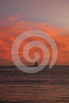 Clouds at sunset with sailboat