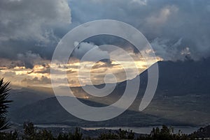 Clouds and sunset with sunbeams over the beginning