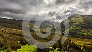 Clouds and sunshine in the green mountains of Snowdonia in Wales.