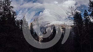 Clouds swirl atop half dome