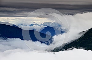 Clouds swirling around and above Carnic and Julian Alps