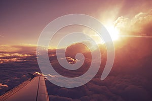 Clouds from the top and dramatic sunset, airplane view