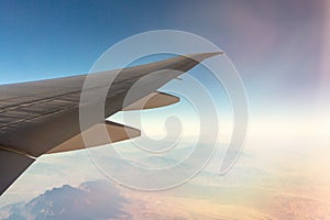 Clouds under the wing of an airplane. Amazing view from the window of the airplane during the flight