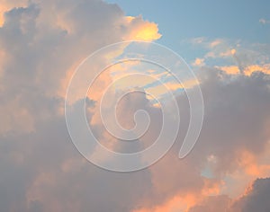 Cloudscape - Abstract Natural Background - Pattern of Yellowish Orange and Dark Cumulonimbus Clouds in Blue Sky