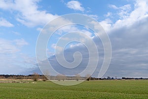 Cloudscape of a cloud band over the meadows near the river Lek Amerongen the Netherlands